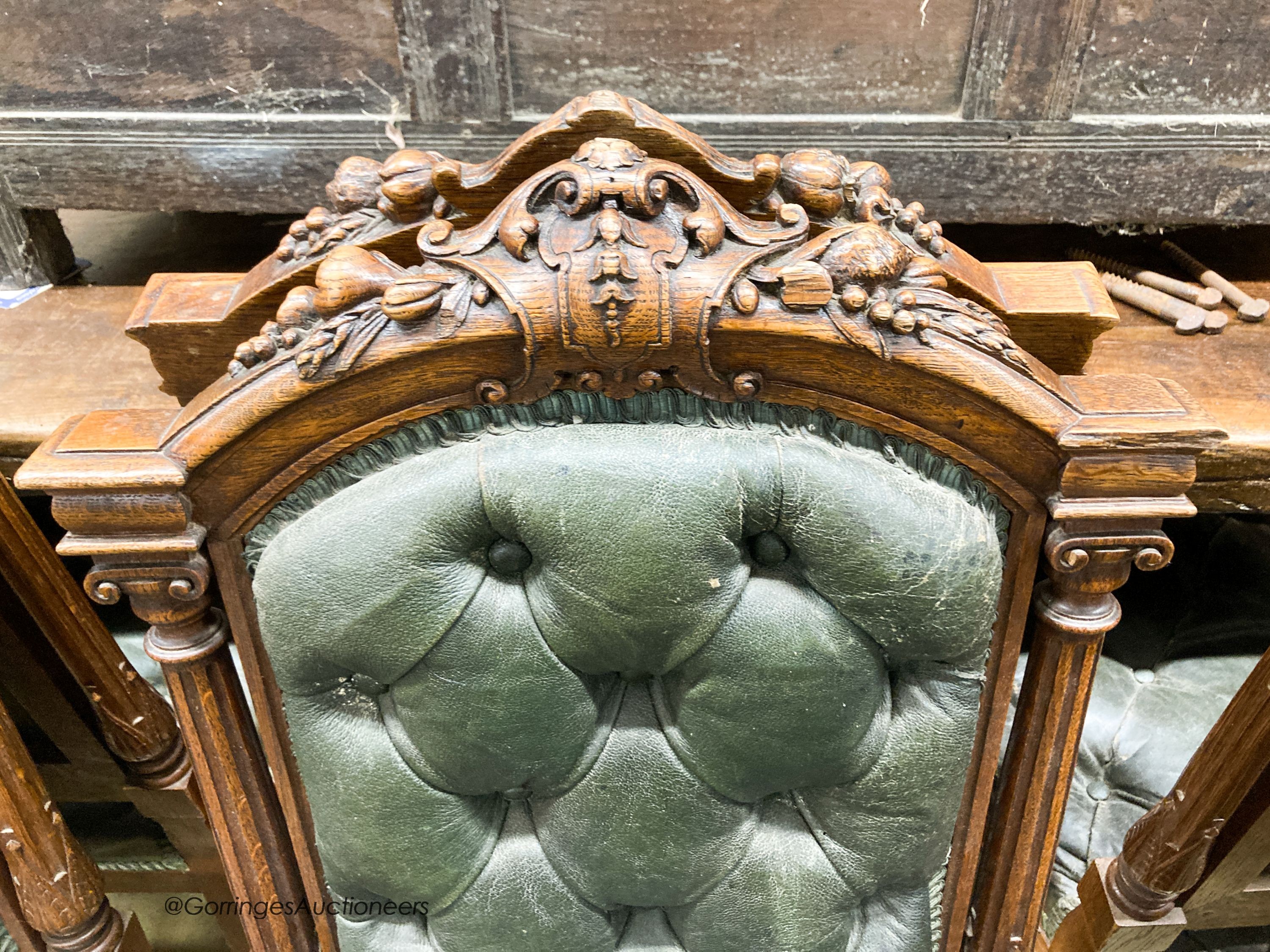 A set of twelve Victorian carved oak buttoned back and seat dining chairs, width 52cm, depth 50cm, height 106cm